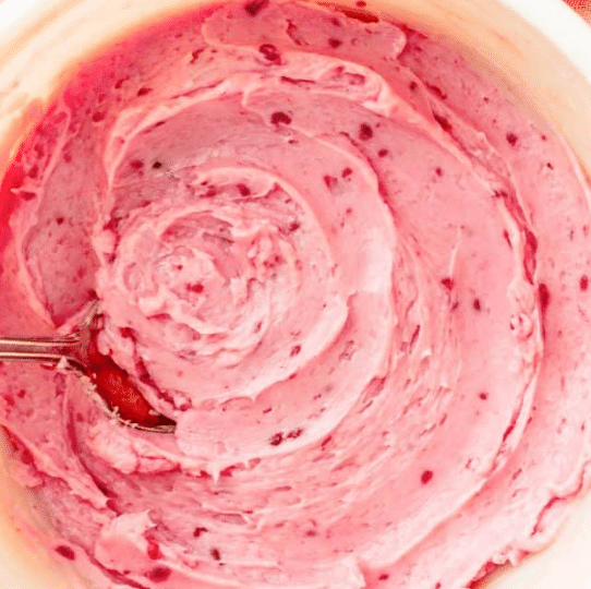 Top down view of a bowl with rasberry honey butter.