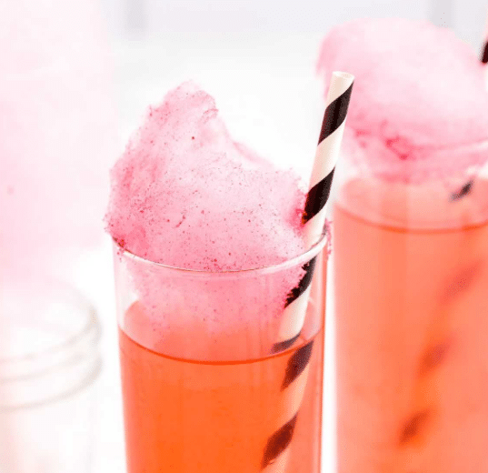Cotton candy cocktail in tall glasses with a straw,