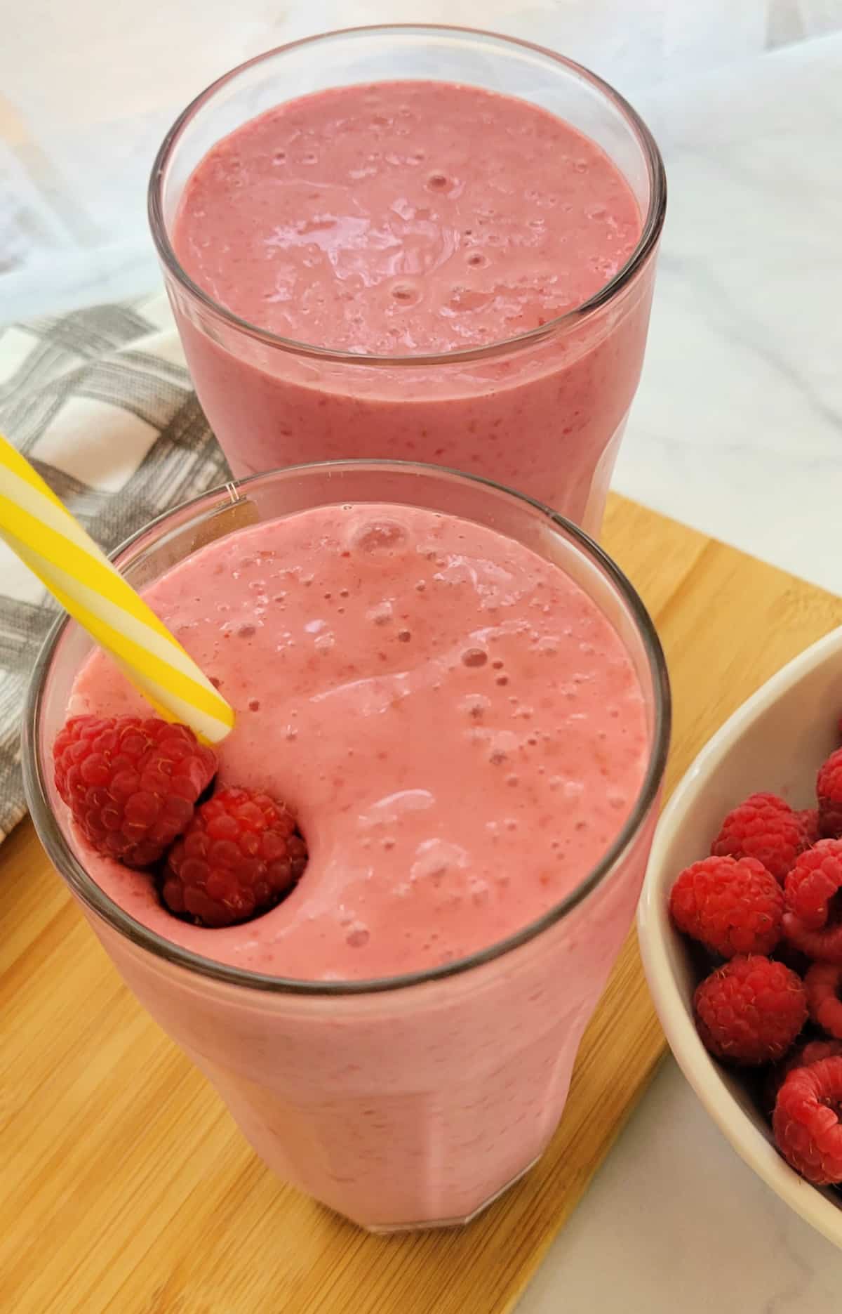 Two Raspberry Smoothies in tall glasses,