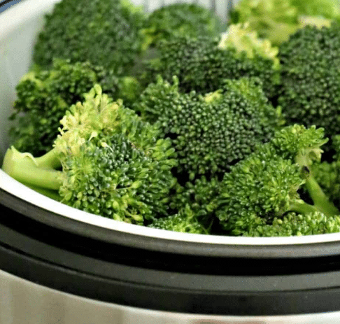 Close up of broccoli in a rice cooker.