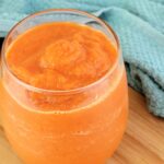 Close up of Carrot Smoothie in a glass.