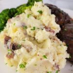 Close up of Red Skin Mashed Potatoes on a plate.