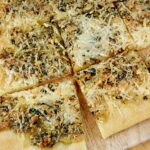 Close up of sliced Tarragon and Walnut Pesto Flatbread.