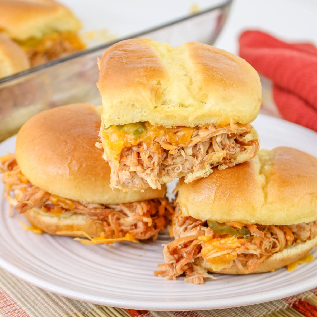 A plate with a stack of sliders made with slow cooker bbq chicken.