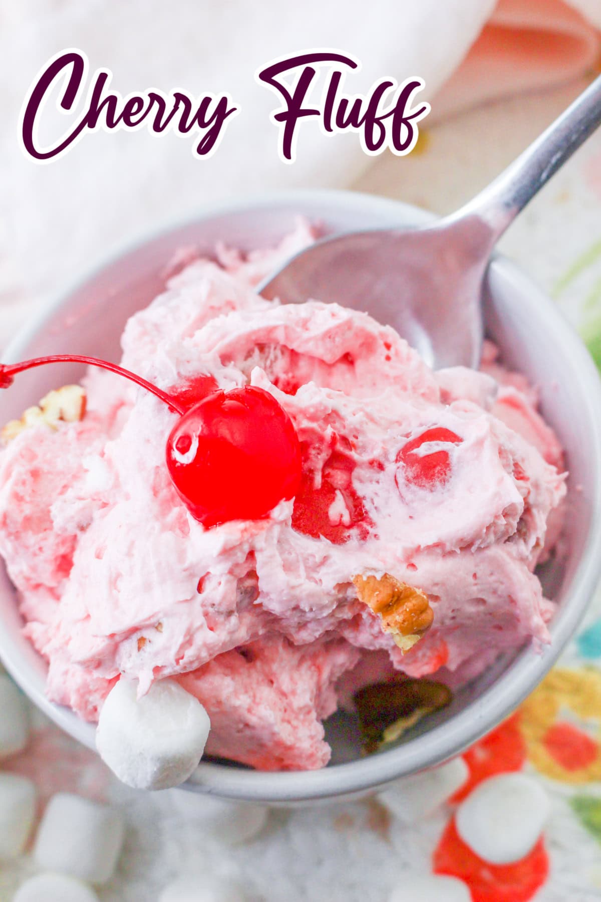 Close up of cherry fluff with marshmallows, pecans, and maraschino cherries.