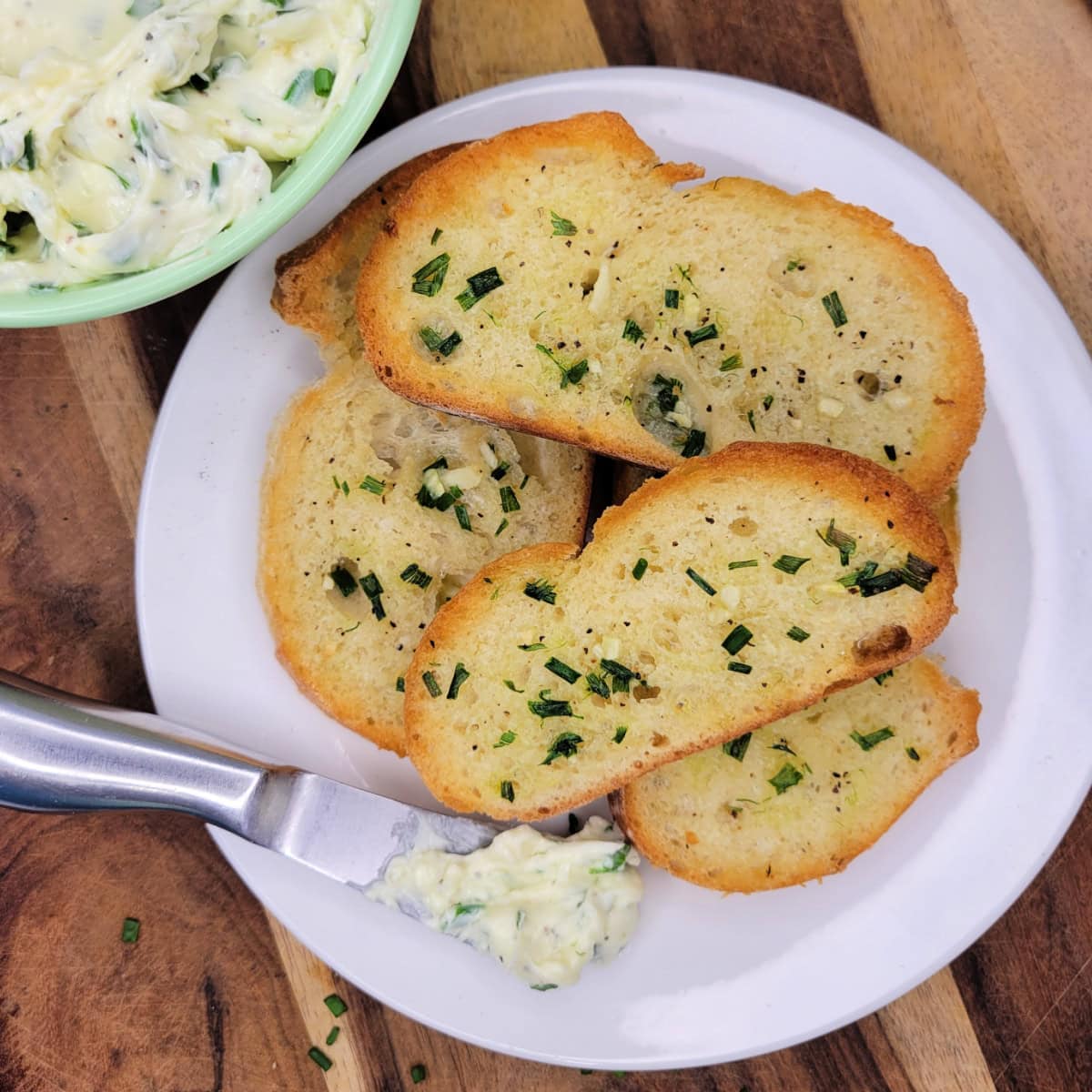Plate of chive garlic bread with chive butter.
