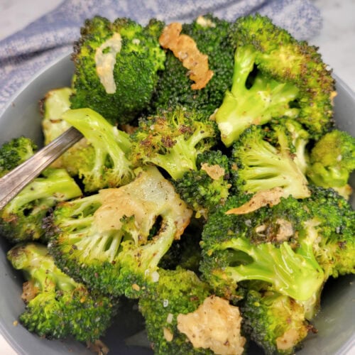 Close up of parmesan and garlic broccoli in a bowl.