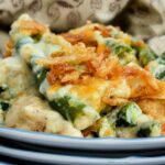 Close up of Top down view of green bean casserole with French onions on a plate.