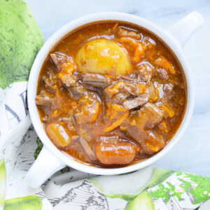 Top down view of Instant Pot beef stew with potatoes, carrots, sweet potatoes, onions, and bottom round roast.
