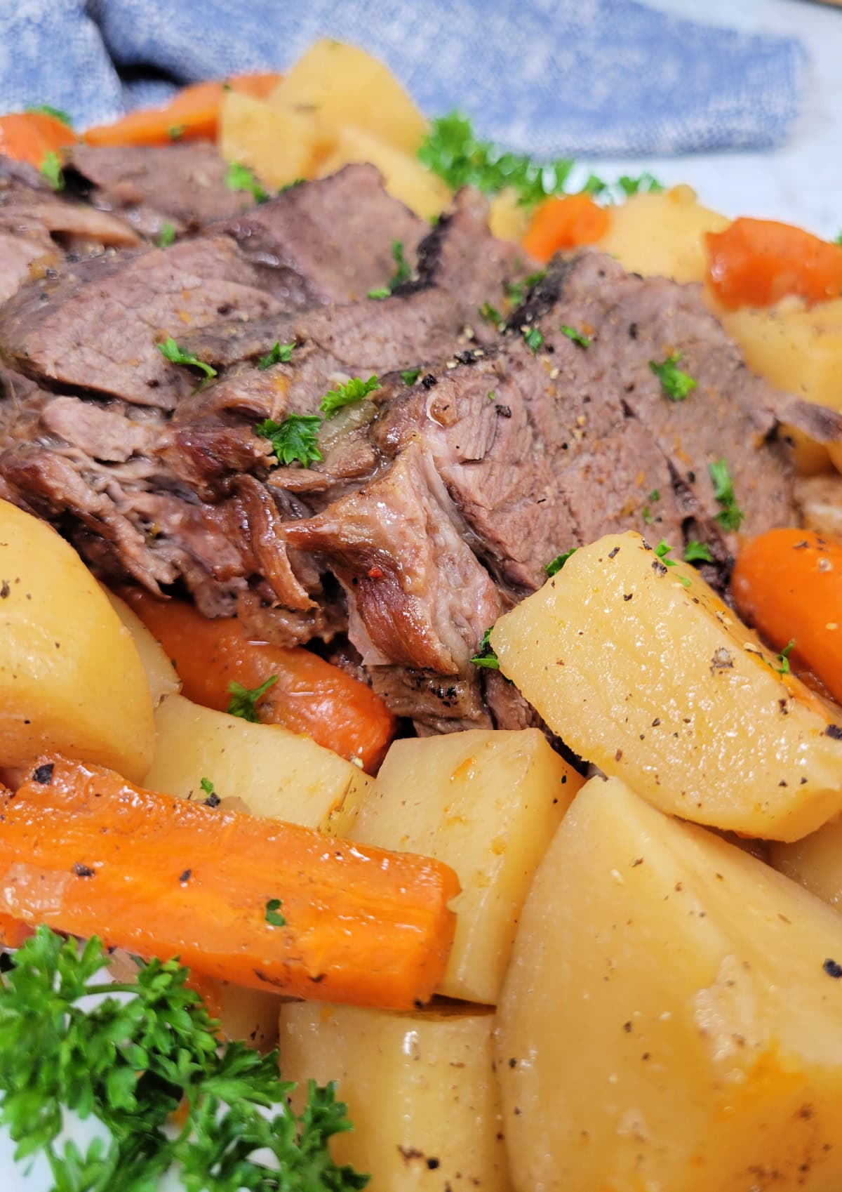 Slices of Italian roast beef with potatoes and carrots.