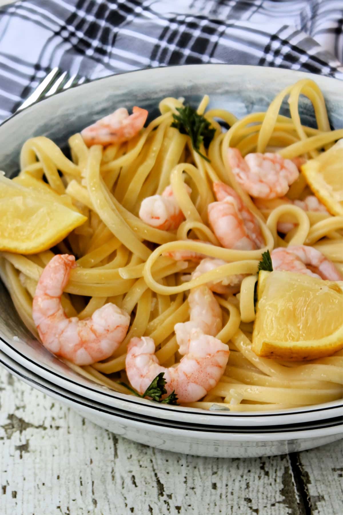 Garlic Lemon Shrimp Scampi in in a bowl with lemons.