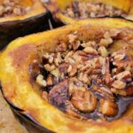 Close up of Maple Roasted Acorn Squash with pecans and brown sugar.