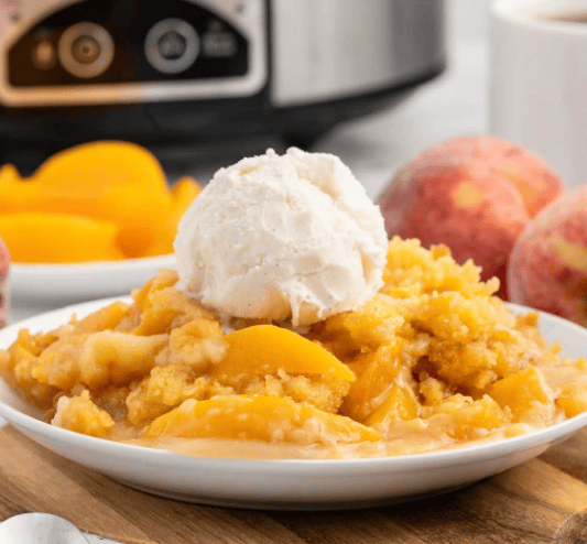 Peach dump cake with a scoop of ice cream.