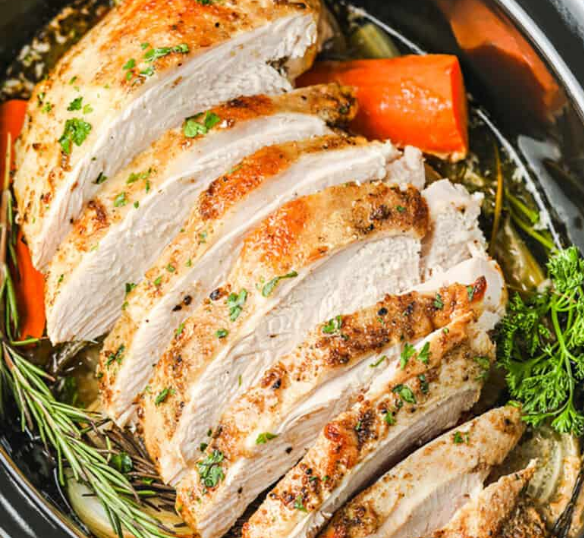 Sliced turkey breast in a crockpot.