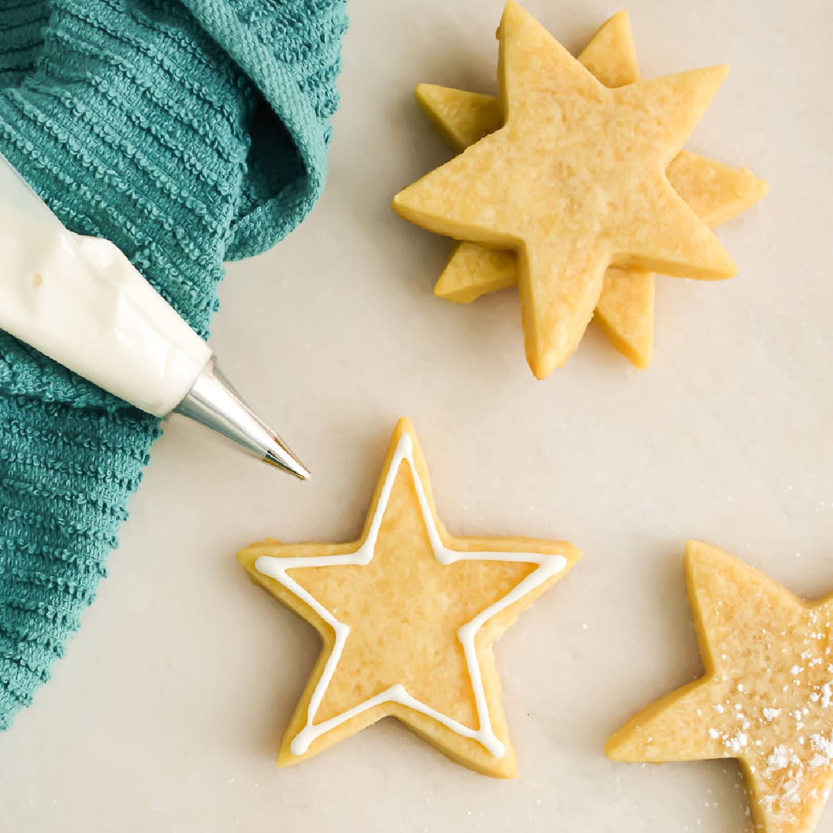 Piping bag with Royal Icing made without merigue powder or egg whites and star cookies
