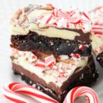 Close up of a stack of brownies with peppermint bark for candy canes.