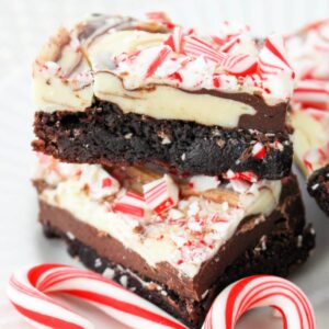 Close up of a stack of brownies with peppermint bark for candy canes.