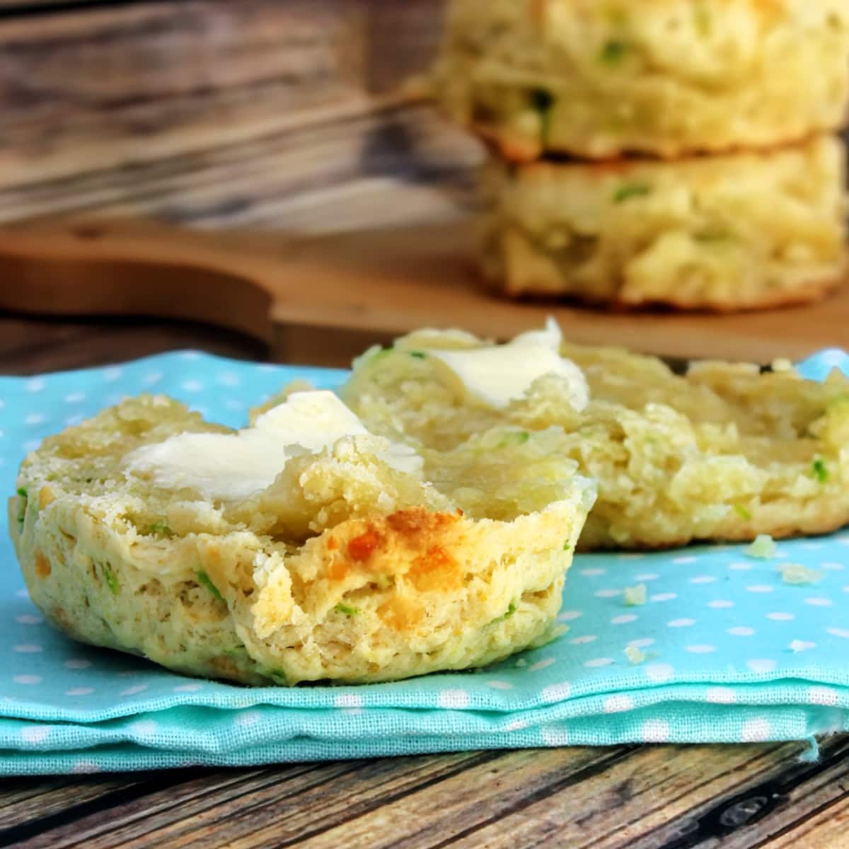 Close up of jalapeno cheese biscuits with butter.