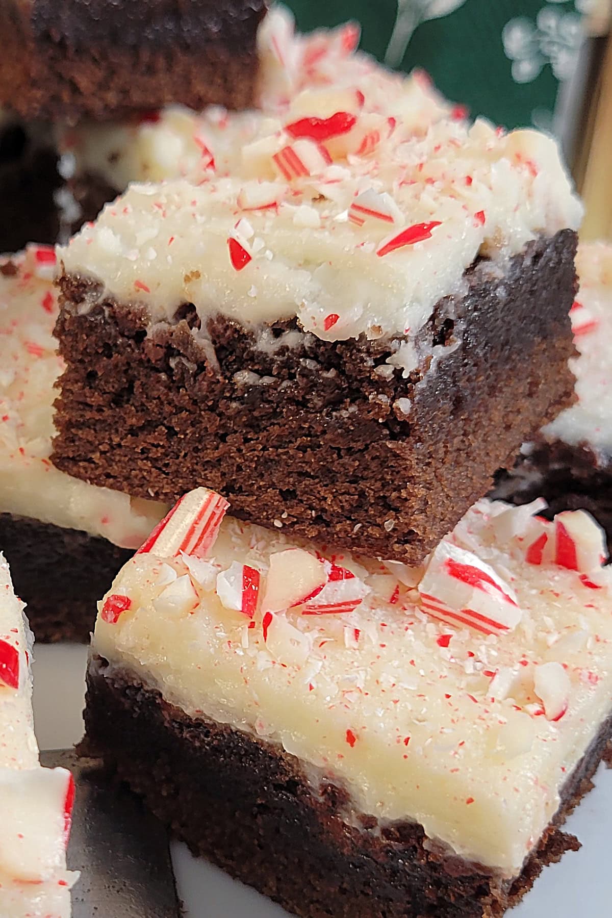 Close up of Peppermint Frosted Brownies with crushed candy canes.