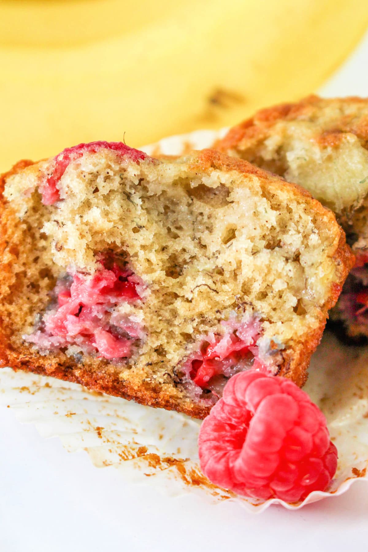 Banana Raspberry Muffins Recipe: close up of banana muffin with raspberries.