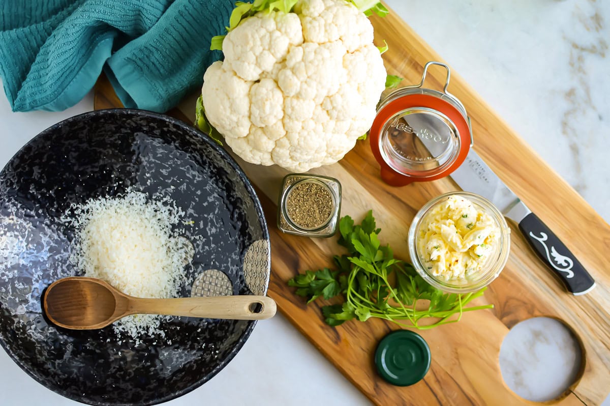 Top down view of Cowboy Butter Cauliflower Bites Recipe Ingredients with a cutting board.