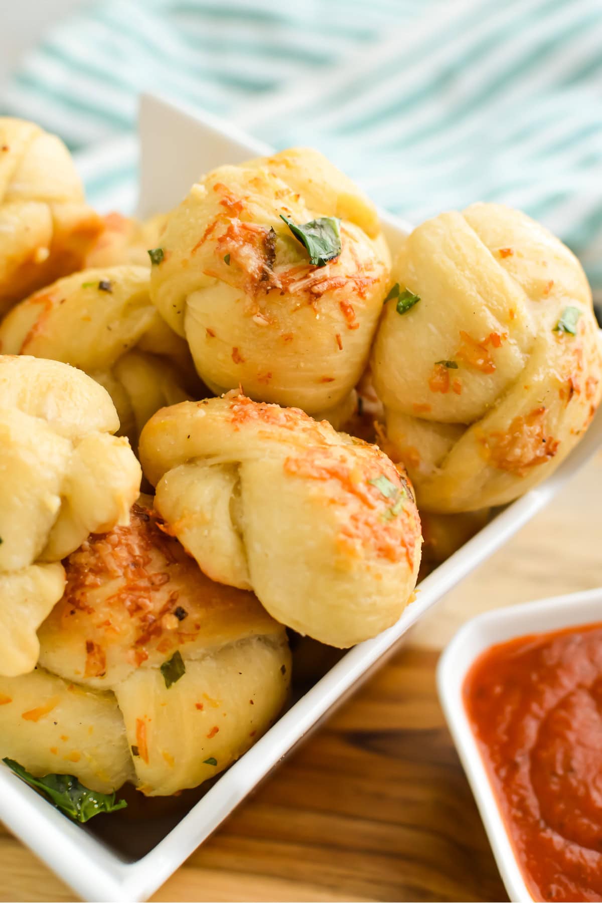 Buttery parmesan garlic knots ina small dish.